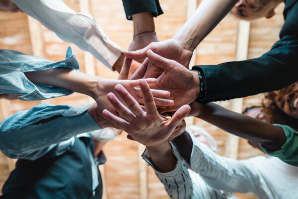 group of businesspeople joining hands together standing in circle creative teamwork building concept